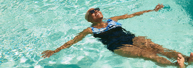 Decorative graphic showing a smiling woman floating in a sparkling, sun-lit pool. 