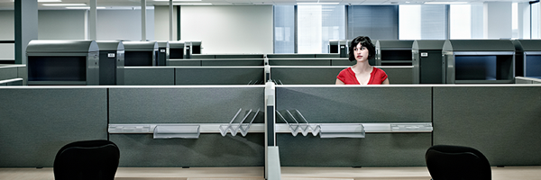 Woman alone in office with cubicles 