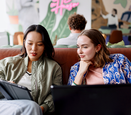 two women looking at a tablet