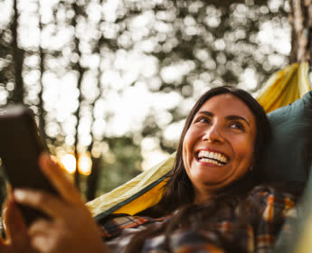 woman smiling looking at phone